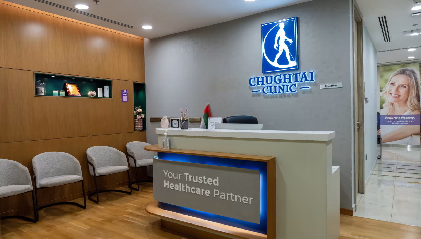 Reception desk and waiting area at Chughtai Clinic Dubai, with the clinic logo and "Your Trusted Healthcare Partner" sign