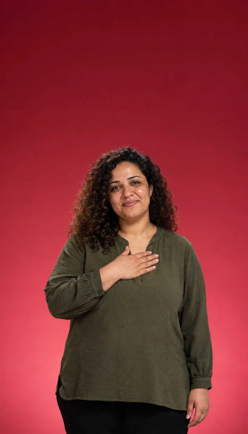 Woman with curly hair and a hand on her chest