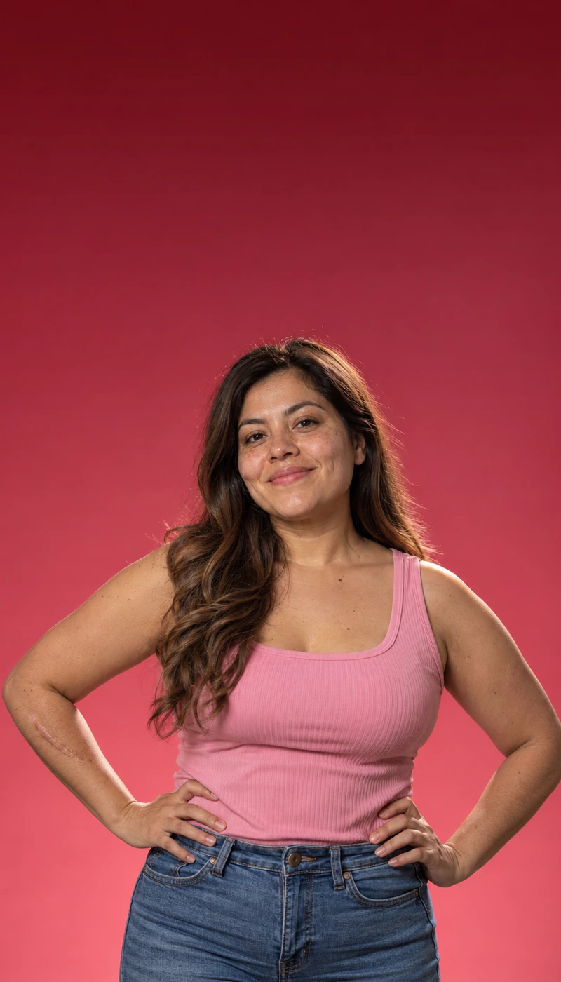 Confident woman in a pink top with hands on hips